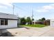 Expansive backyard with a mix of concrete and grassy areas, enclosed by a wooden fence at 461 S Lowell Blvd, Denver, CO 80219