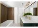 Modern bathroom with double vanity, wood accent wall, and stylish fixtures at 461 S Lowell Blvd, Denver, CO 80219