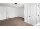 Cozy bedroom features neutral carpet, crisp white walls, and a modern, white paneled door at 461 S Lowell Blvd, Denver, CO 80219