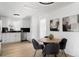 Bright dining area adjacent to a modern kitchen, featuring a round table with seating for four at 461 S Lowell Blvd, Denver, CO 80219