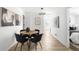 Cozy dining area with a round table and chairs, leading to a hallway with bedrooms and lots of natural light at 461 S Lowell Blvd, Denver, CO 80219