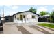 Charming home featuring a modern, recently updated exterior with green door and black trim at 461 S Lowell Blvd, Denver, CO 80219