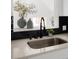 Modern kitchen sink with matte black faucet and decorative backsplash with open view at 461 S Lowell Blvd, Denver, CO 80219