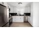 Modern kitchen features white cabinetry, stainless steel appliances, black subway tile backsplash, and wood flooring at 461 S Lowell Blvd, Denver, CO 80219