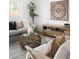 Comfortable living room with modern furnishings, a gray sofa, chairs, and a striking art piece at 461 S Lowell Blvd, Denver, CO 80219