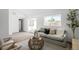 Comfortable living room featuring cozy seating, neutral tones, and a sliding glass door at 461 S Lowell Blvd, Denver, CO 80219