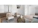 Bright living space features two chairs, light walls, and a decorative vase on a table, with a doorway on the right at 461 S Lowell Blvd, Denver, CO 80219