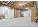 Unfinished basement features concrete floor, exposed ceiling, a small window and door at 8057 Monte Vista Cir, Littleton, CO 80125