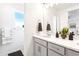 Modern bathroom featuring double vanity, white countertops, and decorative towels at 8057 Monte Vista Cir, Littleton, CO 80125