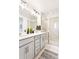 Contemporary bathroom showcasing double vanity, recessed lighting, and a glass-enclosed shower at 8057 Monte Vista Cir, Littleton, CO 80125