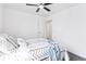 Bright bedroom features modern ceiling fan and a comfortable bed with stylish patterned bedding at 8057 Monte Vista Cir, Littleton, CO 80125