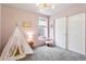Charming bedroom with a play teepee, pink walls, and a cozy atmosphere at 8057 Monte Vista Cir, Littleton, CO 80125