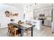 Open concept dining and kitchen area with modern lighting and decor at 8057 Monte Vista Cir, Littleton, CO 80125