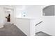 Bright upstairs hallway with carpeted floors and white walls leading to other rooms at 8057 Monte Vista Cir, Littleton, CO 80125