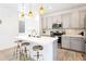 Modern kitchen featuring a center island, pendant lighting, and stainless steel appliances at 8057 Monte Vista Cir, Littleton, CO 80125