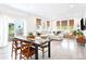 Open concept living area with dining room visible to the left with view of the outside at 8057 Monte Vista Cir, Littleton, CO 80125