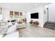 Bright living room with a large sectional sofa, neutral decor, and natural window coverings at 8057 Monte Vista Cir, Littleton, CO 80125