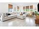 Spacious living room featuring a large sectional sofa, neutral decor, and natural window coverings at 8057 Monte Vista Cir, Littleton, CO 80125