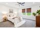 Cozy bedroom with a ceiling fan, natural light and a view of the backyard through woven blinds at 8057 Monte Vista Cir, Littleton, CO 80125