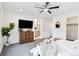 Comfortable main bedroom showcasing an ensuite bathroom, contemporary decor, and a ceiling fan at 8057 Monte Vista Cir, Littleton, CO 80125