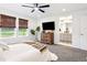 Bright main bedroom featuring neutral decor, a ceiling fan, and an ensuite bathroom with double vanity at 8057 Monte Vista Cir, Littleton, CO 80125