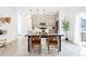 Open concept dining and kitchen area with modern lighting and decor at 8057 Monte Vista Cir, Littleton, CO 80125