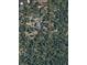 An aerial view of a home nestled among lush trees on a large lot with defined property lines at 20496 Stonewood Trl, Morrison, CO 80465