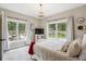 Cozy bedroom with large windows offering scenic views and a stylish chandelier at 20496 Stonewood Trl, Morrison, CO 80465