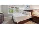 Inviting bedroom with a dark wood bed frame, scenic window views, and stylish decor at 20496 Stonewood Trl, Morrison, CO 80465
