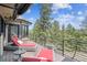 Outdoor deck with mountain view, lounge chairs, shade covering, and black railings at 20496 Stonewood Trl, Morrison, CO 80465
