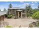 Inviting home exterior with a stone entryway, wood facade, and lush landscaped front yard at 20496 Stonewood Trl, Morrison, CO 80465