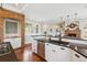 Kitchen sink with stainless steel appliances, white cabinets and countertops, and hardwood flooring at 20496 Stonewood Trl, Morrison, CO 80465