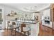 Bright kitchen featuring an island with seating, stainless steel appliances, hardwood flooring, and windows at 20496 Stonewood Trl, Morrison, CO 80465