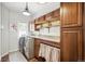 Well-organized laundry room with modern appliances, countertop space, and ample cabinet storage at 20496 Stonewood Trl, Morrison, CO 80465