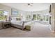Bright main bedroom featuring many windows, neutral tones, a fireplace, and carpet at 20496 Stonewood Trl, Morrison, CO 80465