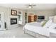 Main bedroom featuring a fireplace, ensuite bathroom, closet, and large bed at 20496 Stonewood Trl, Morrison, CO 80465