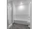 Modern bathroom with a glass-enclosed shower, bathtub, and subway tile at 1438 Little Raven St # 201, Denver, CO 80202