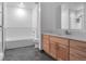 Bright bathroom with double sinks, wood cabinets, and modern fixtures at 1438 Little Raven St # 201, Denver, CO 80202