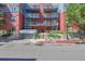 Exterior view of a brick apartment building with multiple balconies and street access at 1438 Little Raven St # 201, Denver, CO 80202