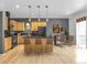 Kitchen with light wood cabinets, black appliances, and a dining area at 1438 Little Raven St # 201, Denver, CO 80202