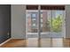 Living room featuring hardwood floors and a large sliding glass door to balcony at 1438 Little Raven St # 201, Denver, CO 80202