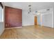 Open concept living area with brick accent wall, hardwood floors, and natural light at 1438 Little Raven St # 201, Denver, CO 80202