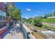 A picturesque riverfront with walkway alongside an apartment building near mature trees at 1438 Little Raven St # 201, Denver, CO 80202