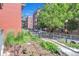 A street view with landscaped area and a sidewalk leading to an apartment complex at 1438 Little Raven St # 201, Denver, CO 80202