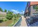 Waterfront view of apartments with patios and river views, along a walkway by the water at 1438 Little Raven St # 201, Denver, CO 80202