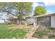 Expansive backyard with ample space for outdoor activities, featuring mature tree providing shade at 6953 Elati Way, Denver, CO 80221