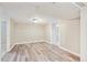 Spacious basement features wood-look flooring, neutral walls, and two doorways at 6953 Elati Way, Denver, CO 80221