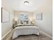 Serene bedroom with neutral walls, comfortable queen bed, soft rug, and two side tables with lamps at 6953 Elati Way, Denver, CO 80221