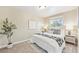 Cozy bedroom features a plush bed with decorative pillows, a window, and modern décor at 6953 Elati Way, Denver, CO 80221