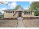 Charming brick home featuring a unique triangular roof design and well-maintained landscaping at 6953 Elati Way, Denver, CO 80221